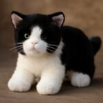 Orange cat stuffed animal with tuxedo cat stuffed animal